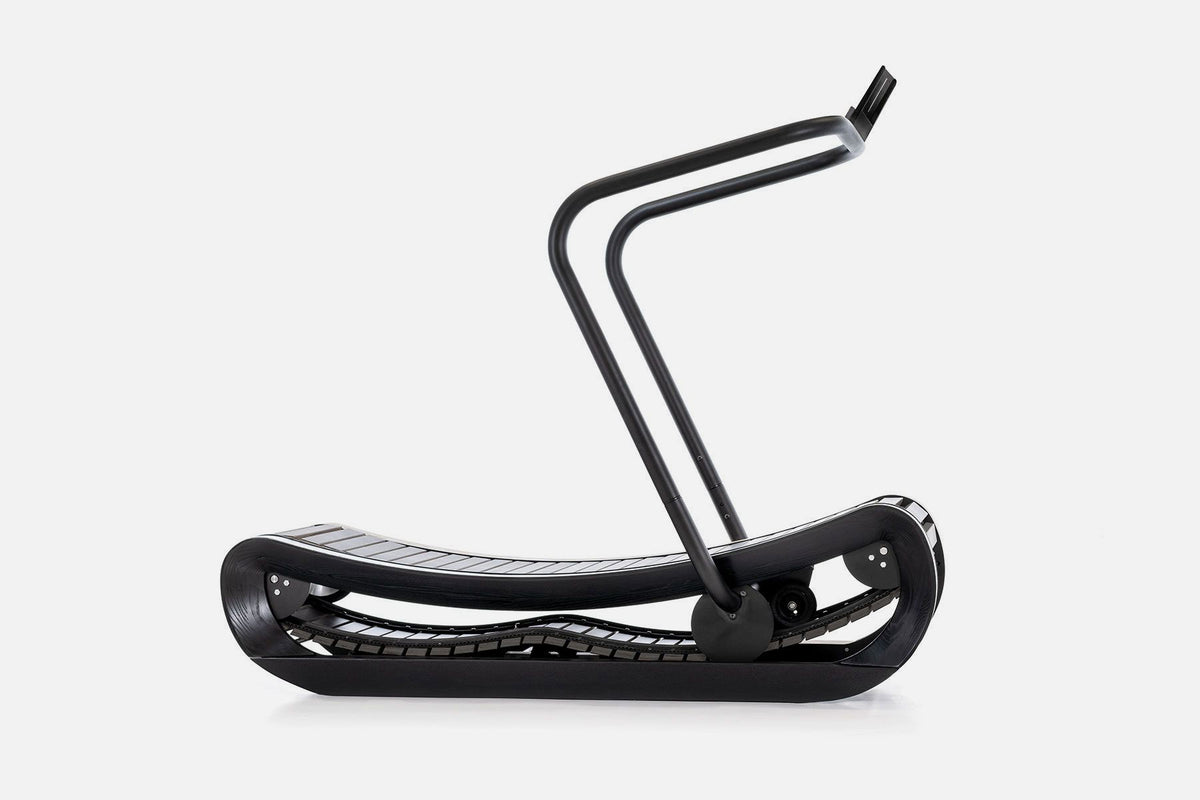 Side view of a curved manual treadmill with a black wood frame, black slats, and a raised black handlebar