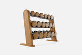 Three-tier cherry-wood rack holding nine pairs of nickel-plated dumbbells with warm golden wood end caps