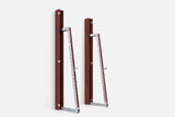 Two wall-mounted squat racks in dark reddish-brown wood, one folded shut and one opened to a silver ladder