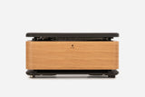 Front view of a pale oak storage bench with the padded lid raised and resistance bands visible inside