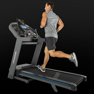 Horizon 7.4AT-02 Treadmill Best Entry Level Treadmill man running with connected bluetooth tablet